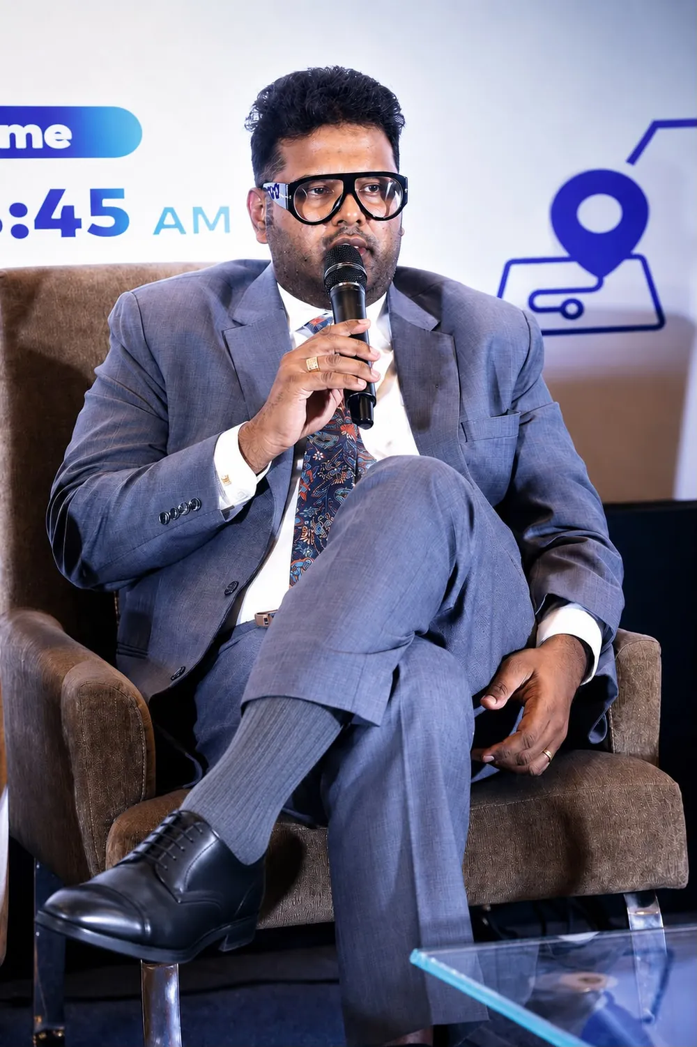 Dr. Koushik speaking during a seated panel discussion.